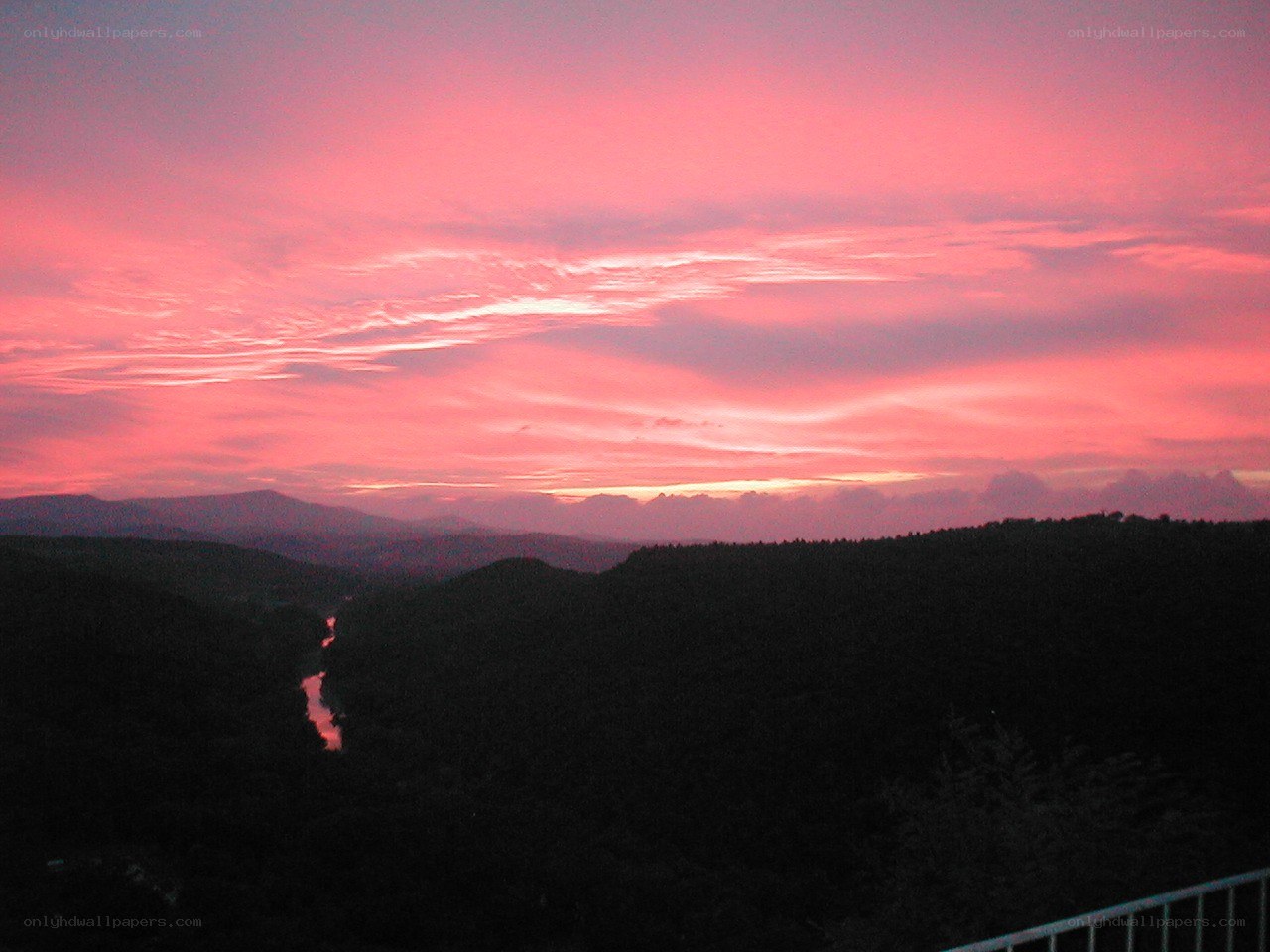 Pink sunset over a river valley
