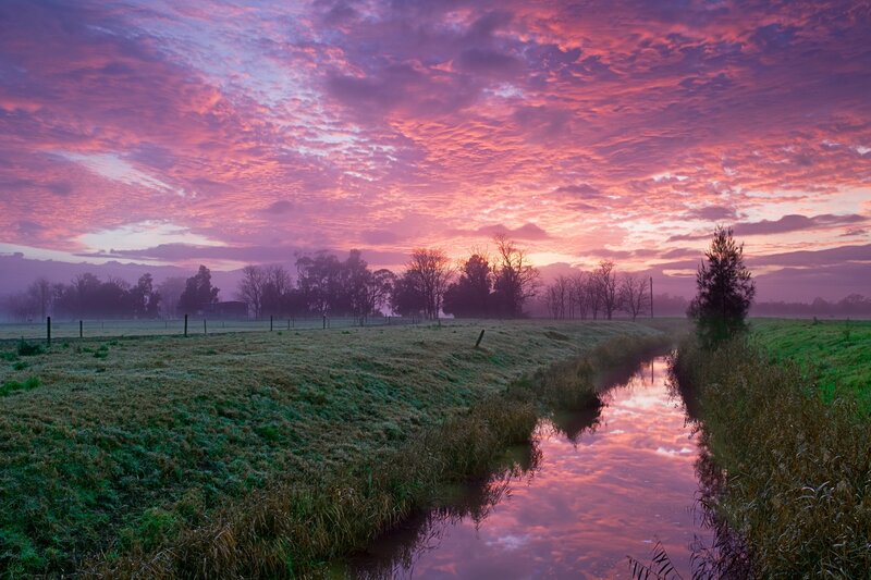 Pink sunset over a rural stream