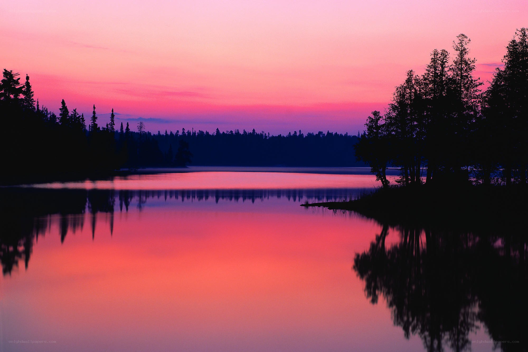 Pink sunset over calm lake