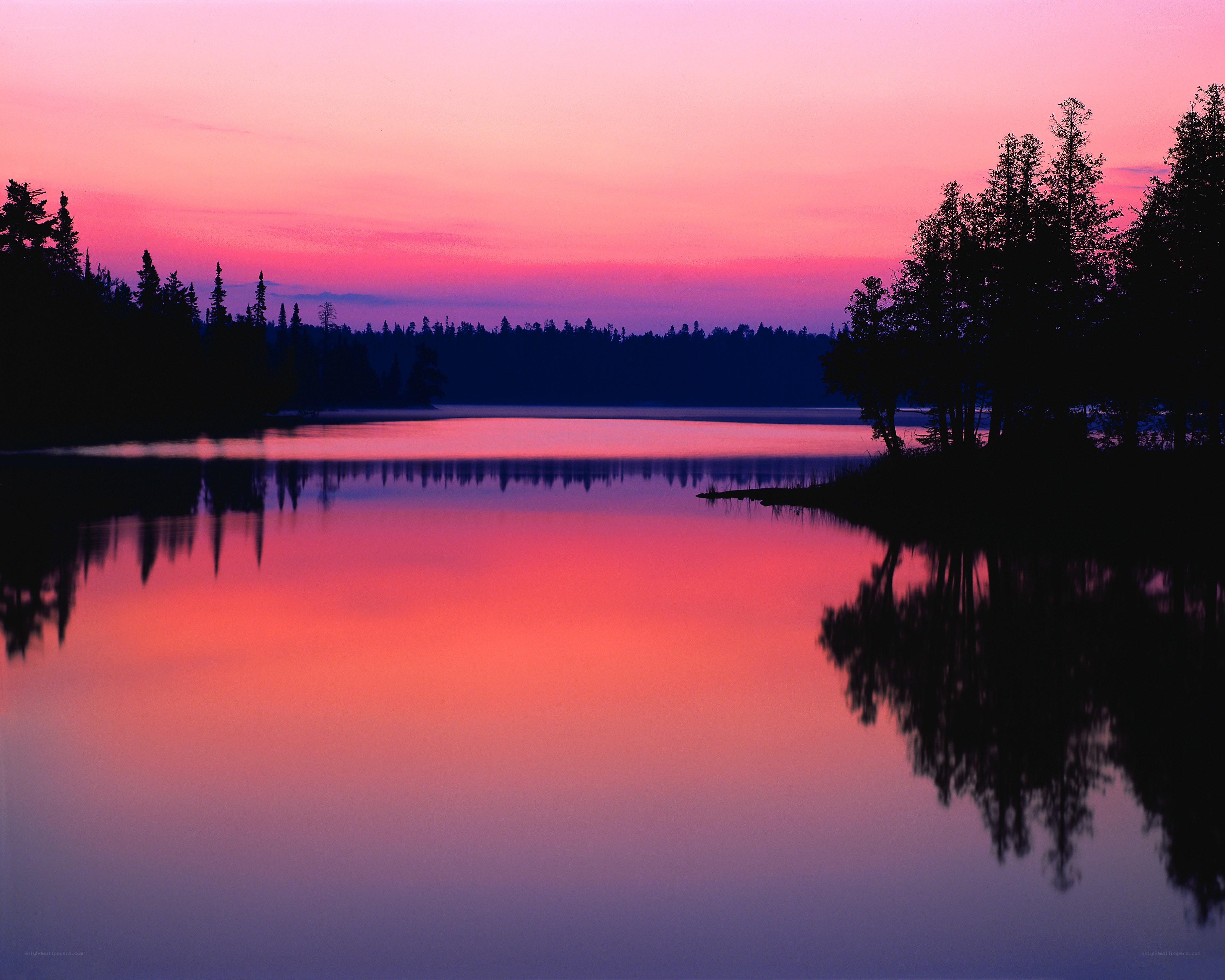 Pink sunset over calm lake