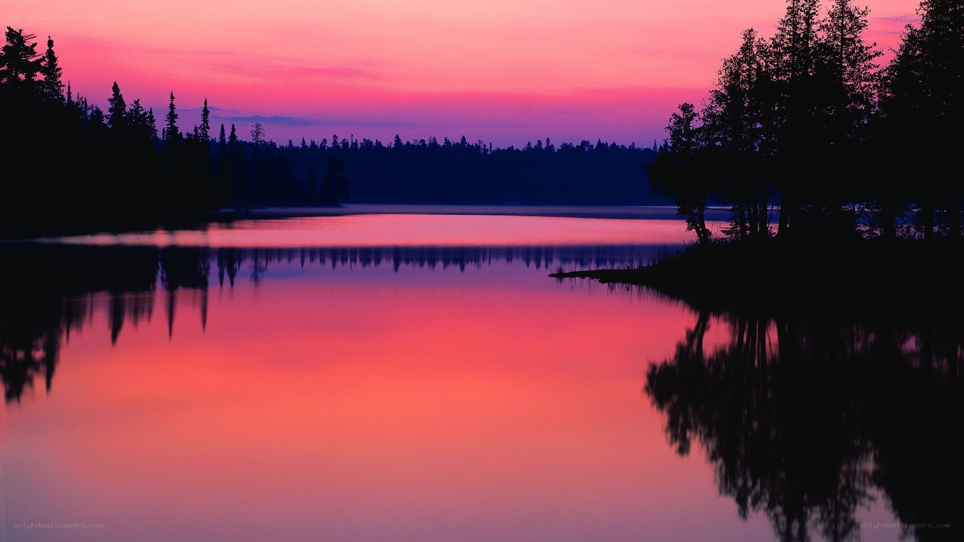 Pink sunset over calm lake