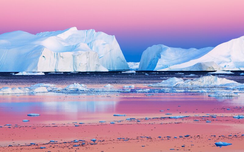 Pink sunset over icebergs