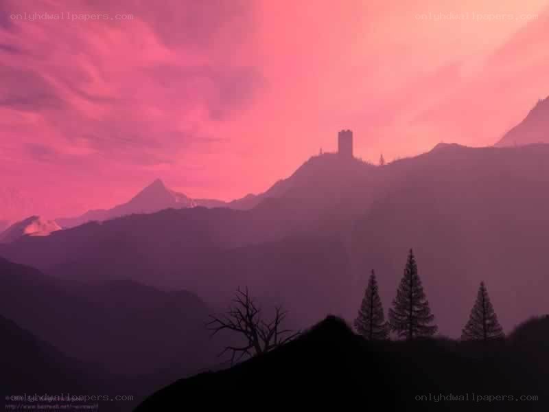 Pink sunset over mountain castle