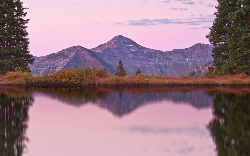 Pink sunset over mountain lake