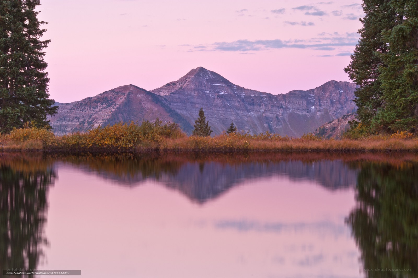 Pink sunset over mountain lake