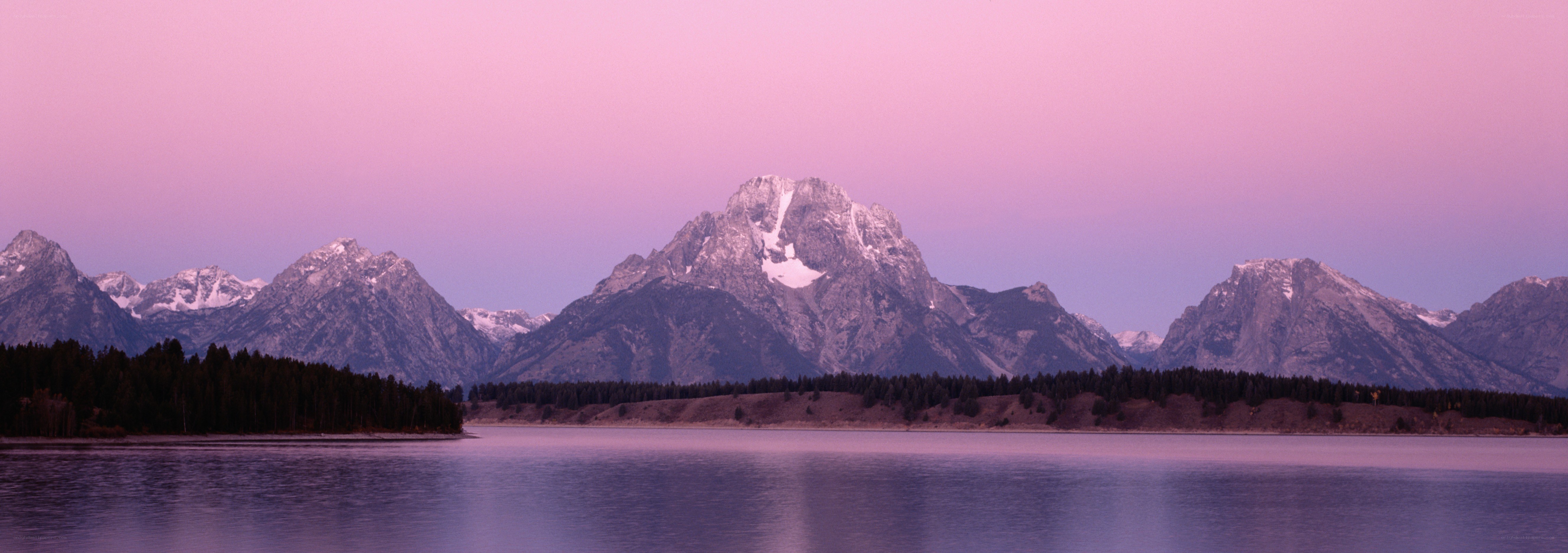 Pink sunset over mountain lake