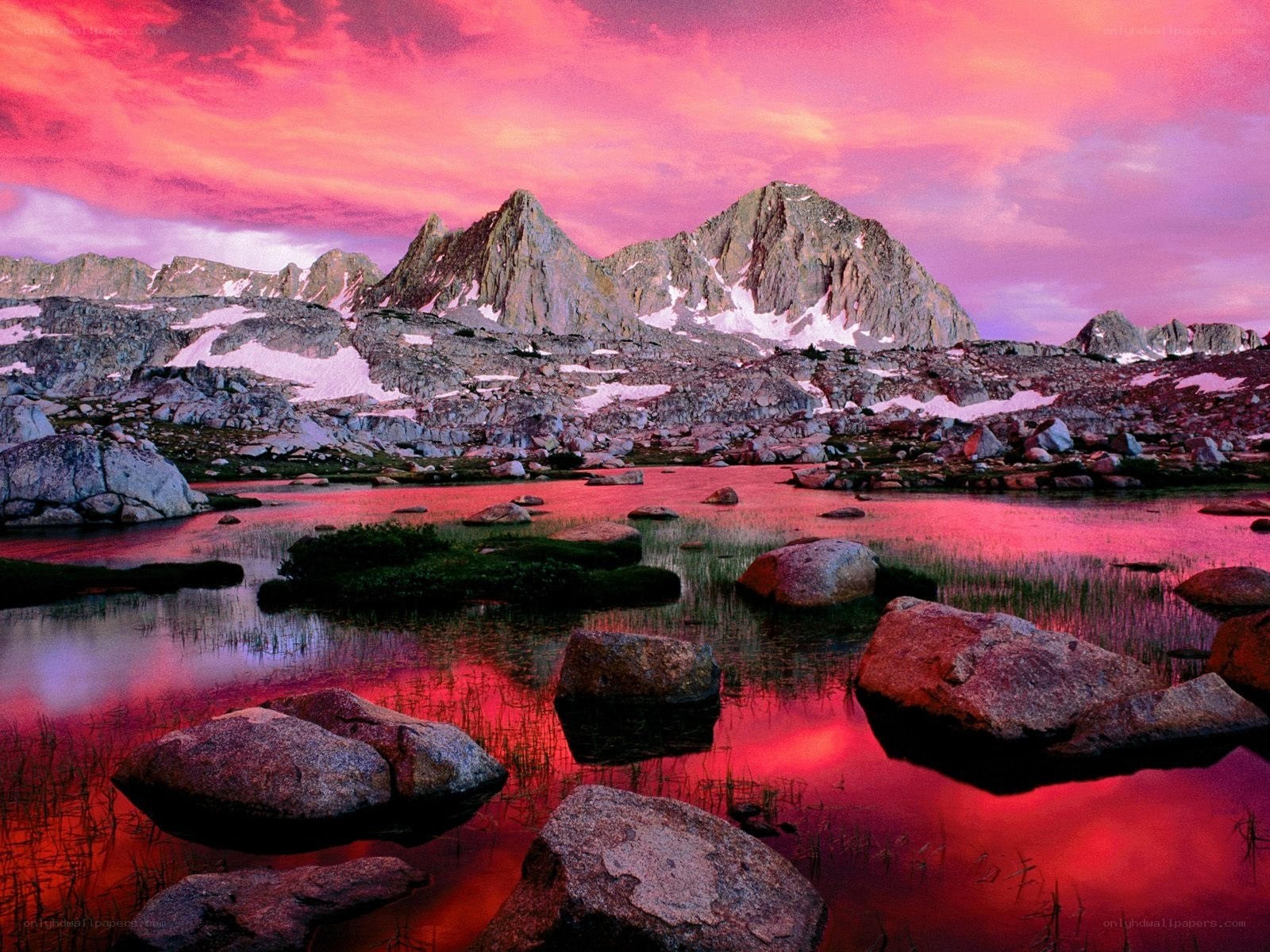 Pink sunset over mountain lake