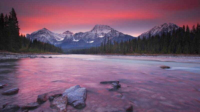 Pink sunset over mountain river
