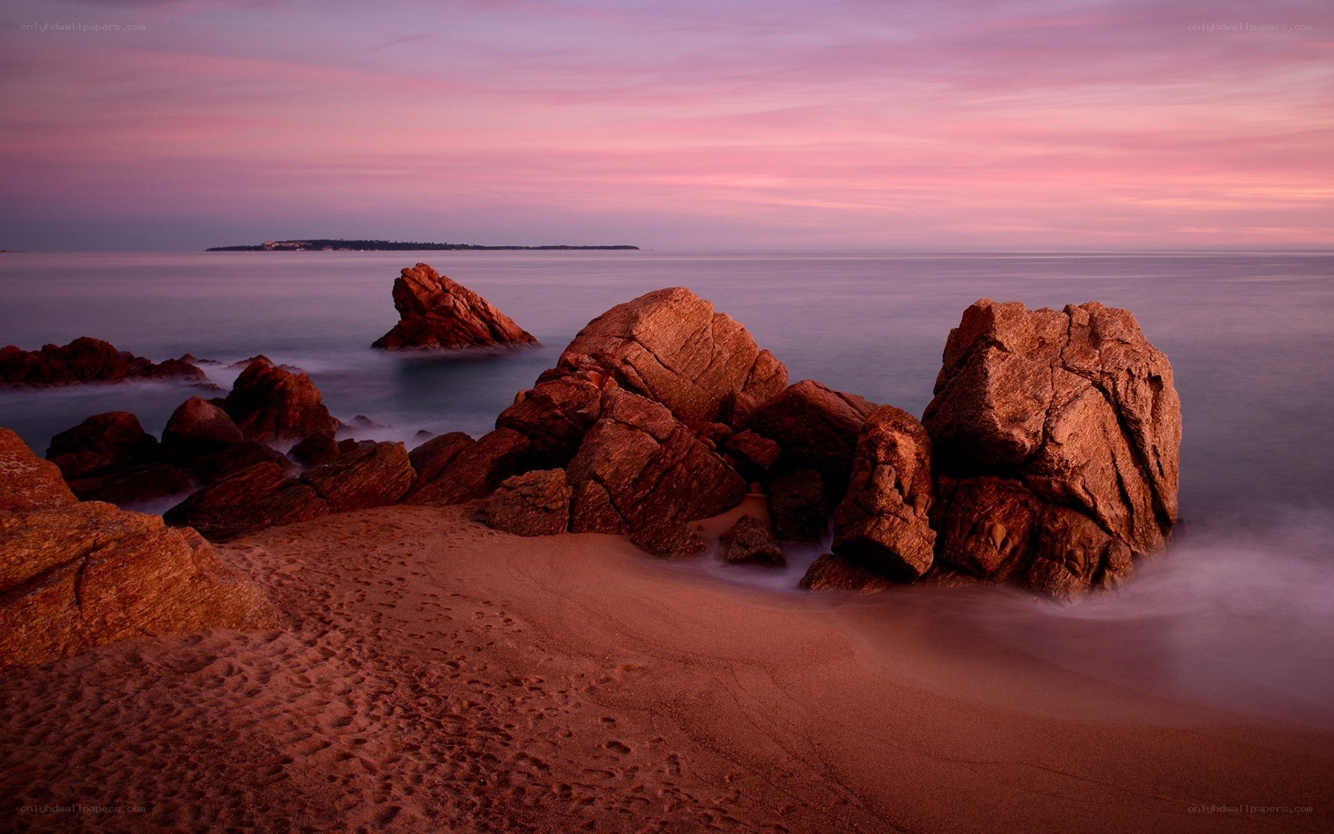 Pink sunset over rocky beach