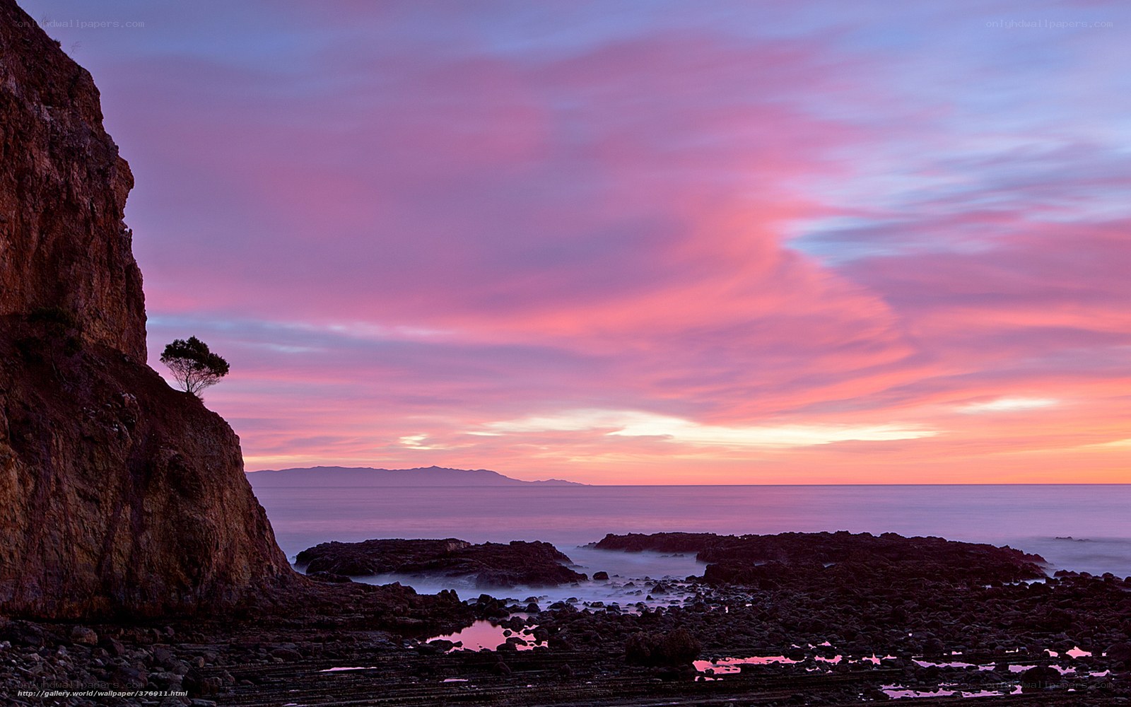 Pink sunset over rocky coast