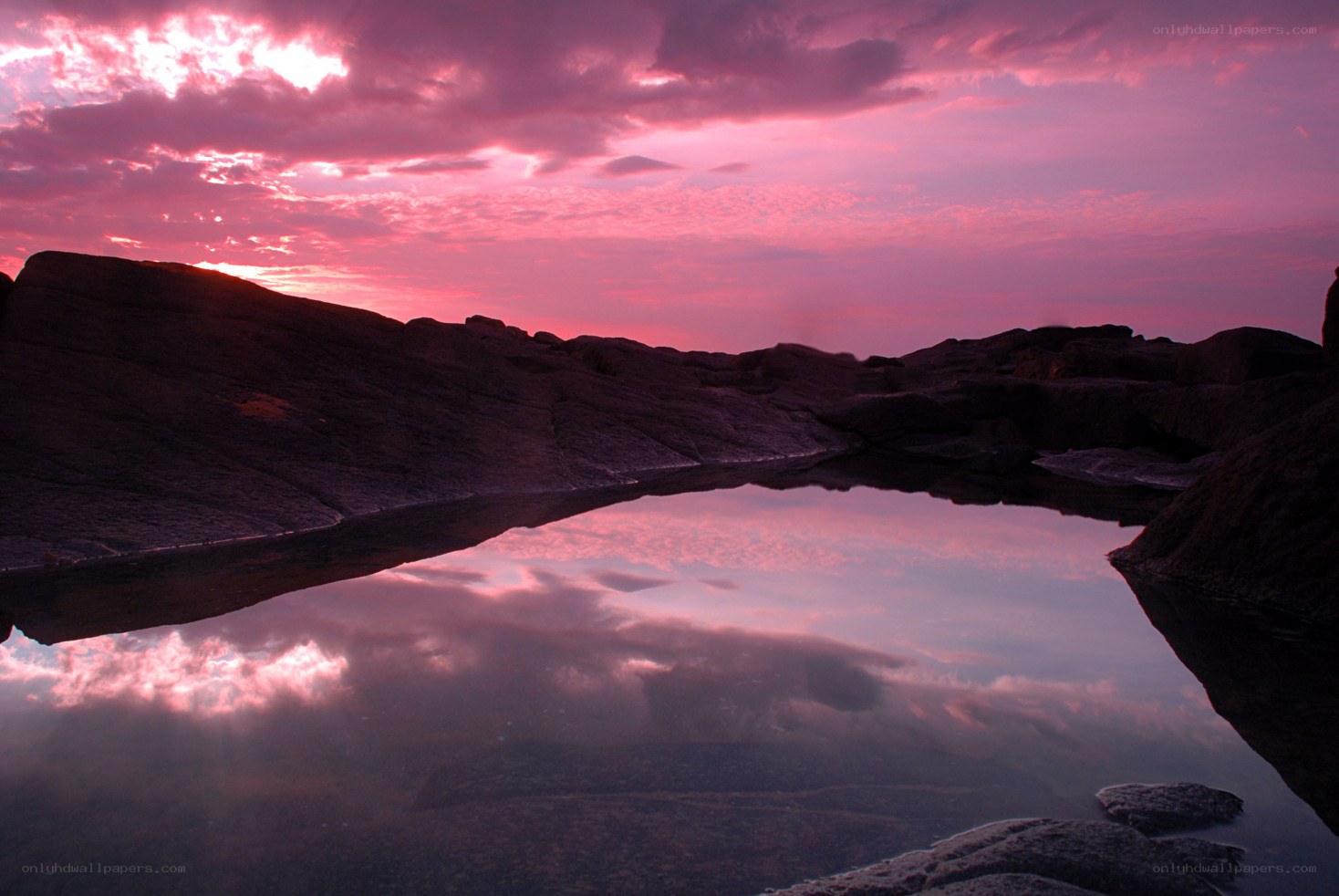 Pink sunset over rocky pool