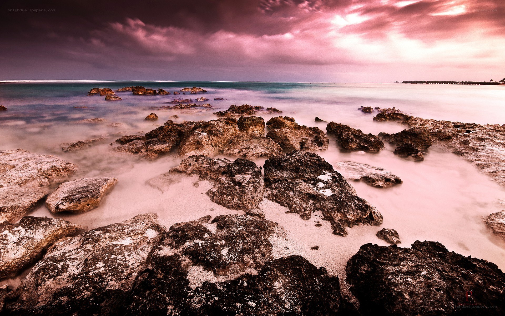 Pink sunset over rocky shore