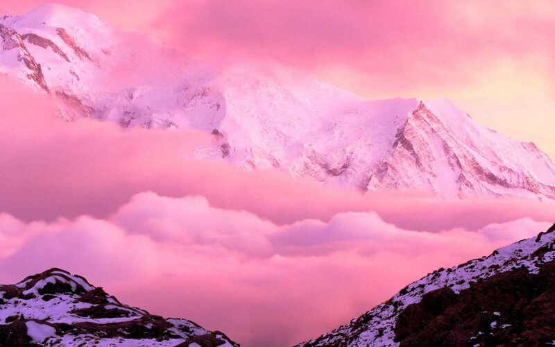 Pink sunset over snow-capped mountains