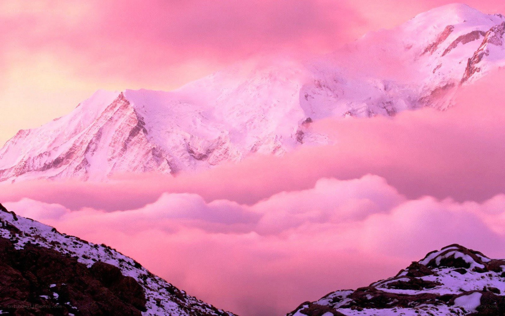 Pink sunset over snow-capped mountains