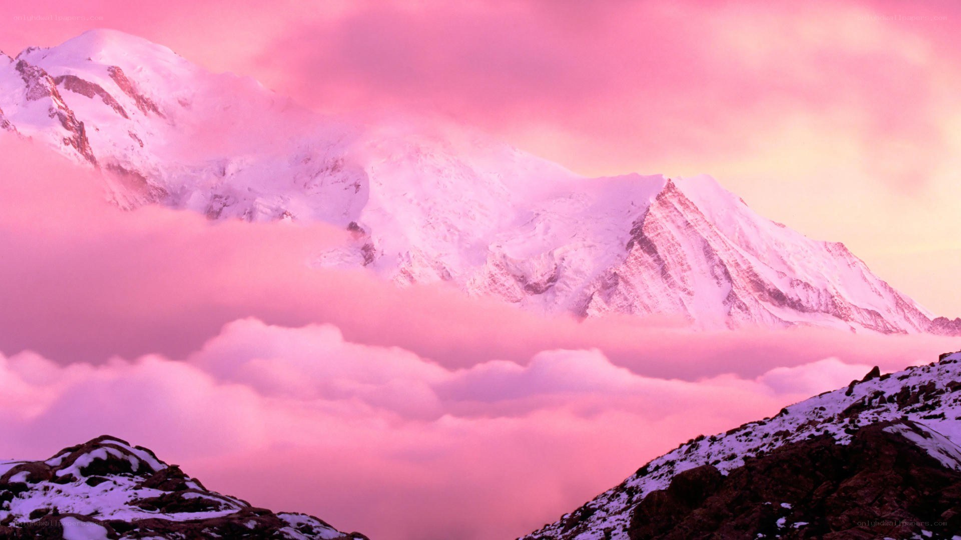 Pink sunset over snow-capped mountains