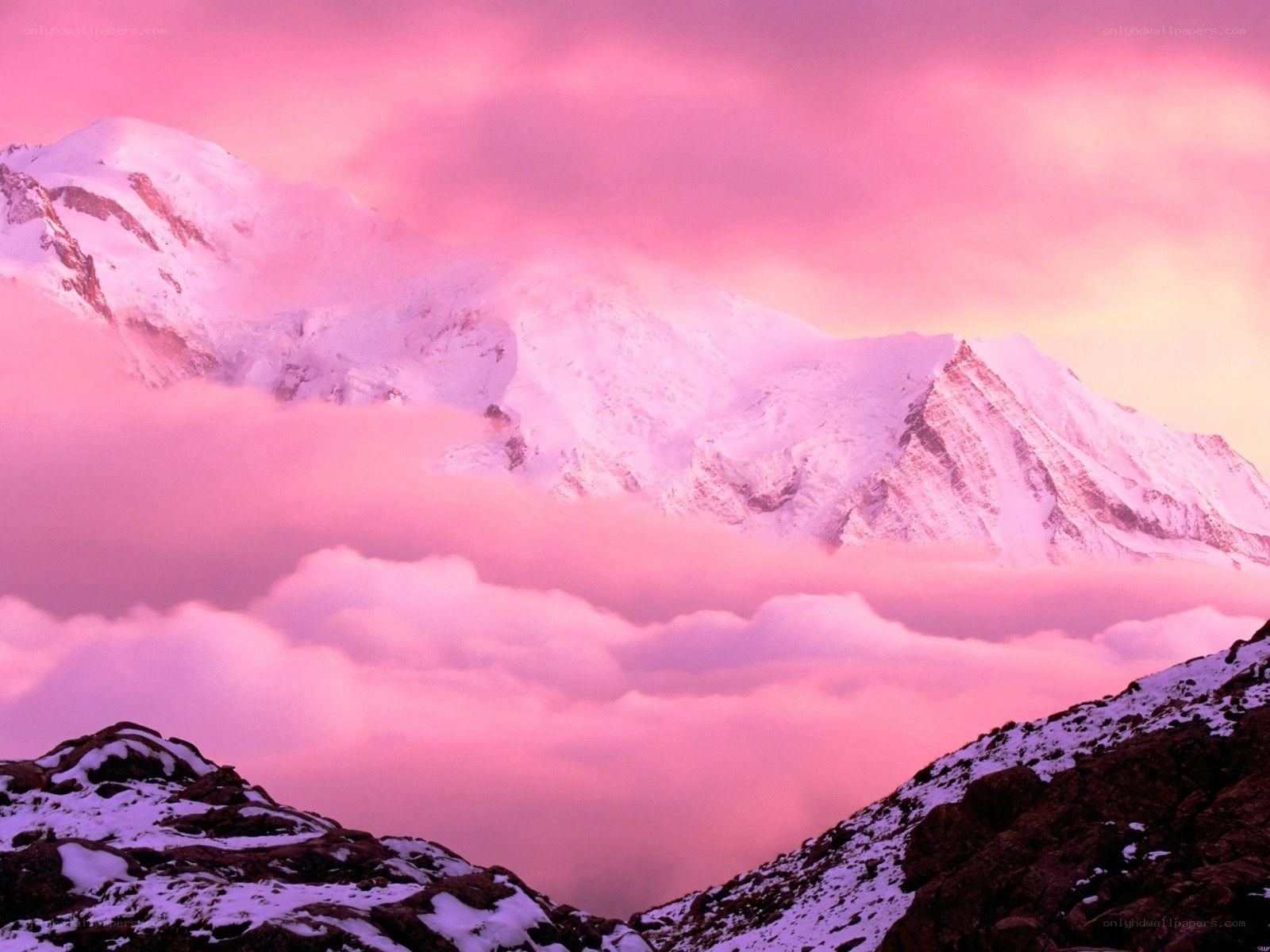 Pink sunset over snowy mountains