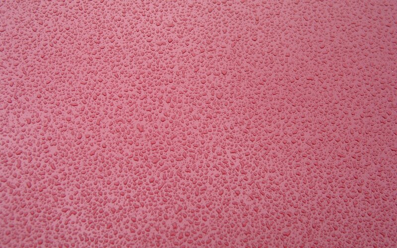 pink surface with water droplets