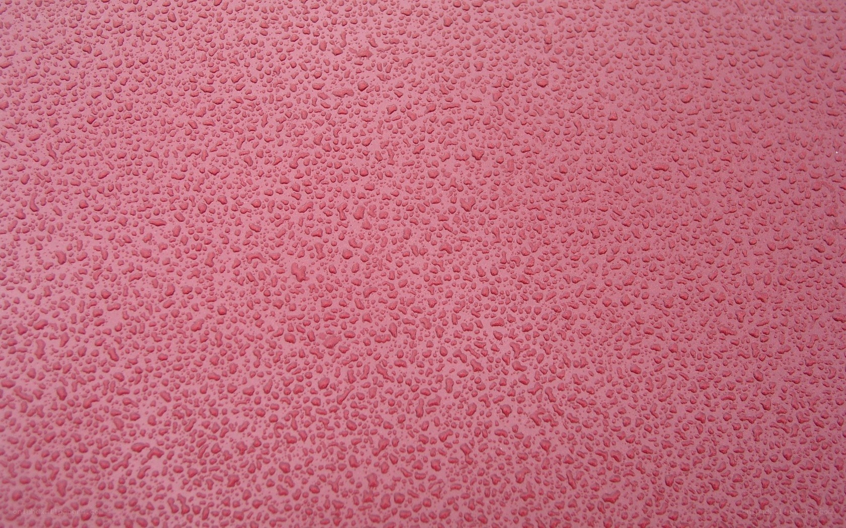 pink surface with water droplets