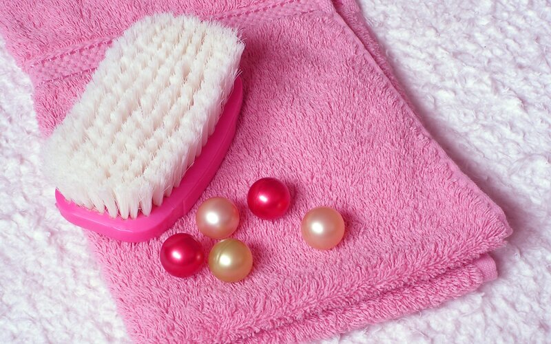 pink towel with brush and pearls