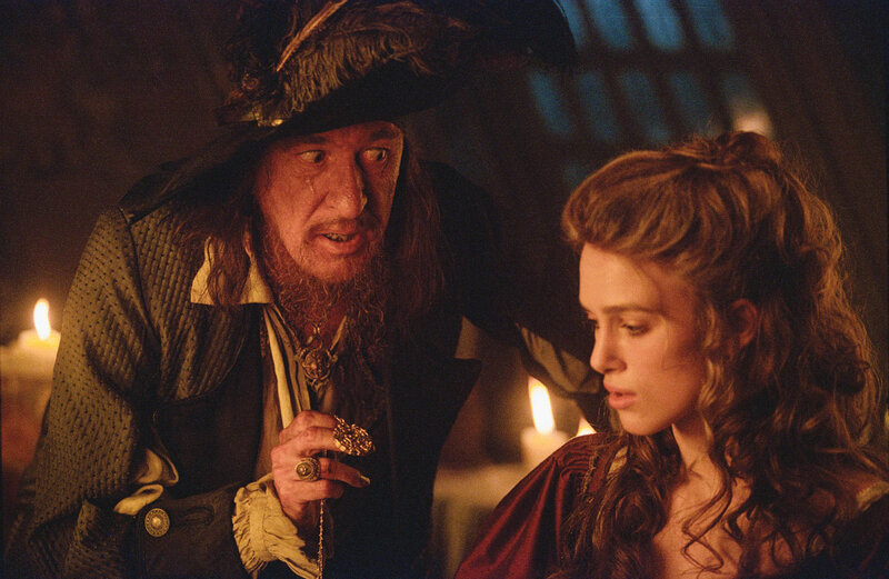 Pirate and woman in candlelight