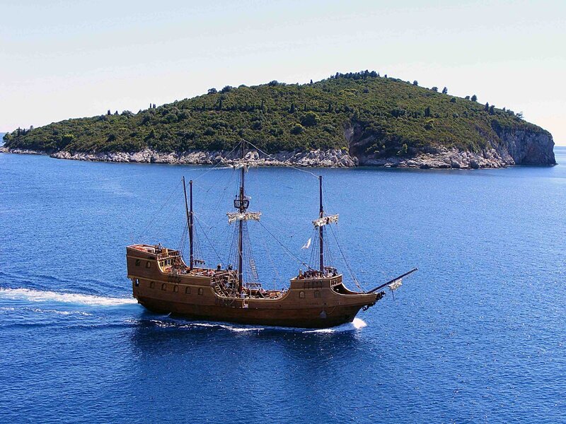 Pirate ship sailing near island