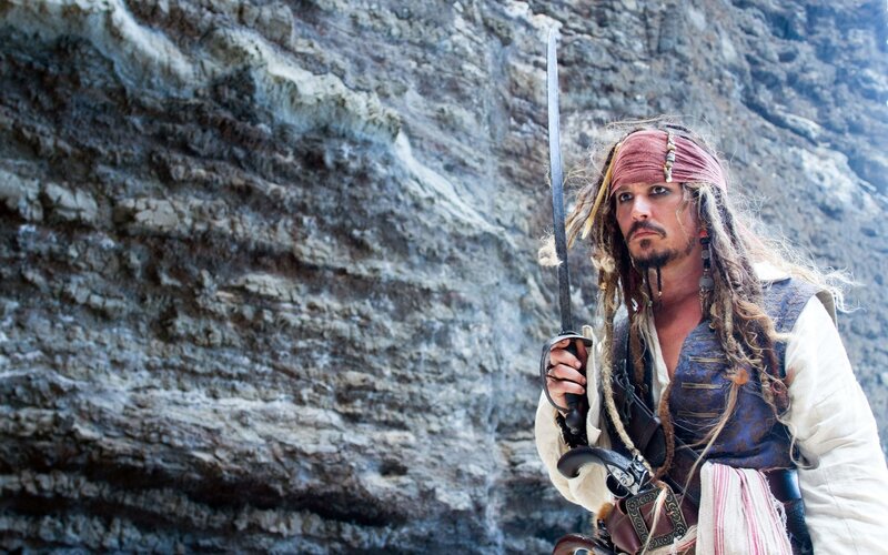 Pirate with sword on cliff