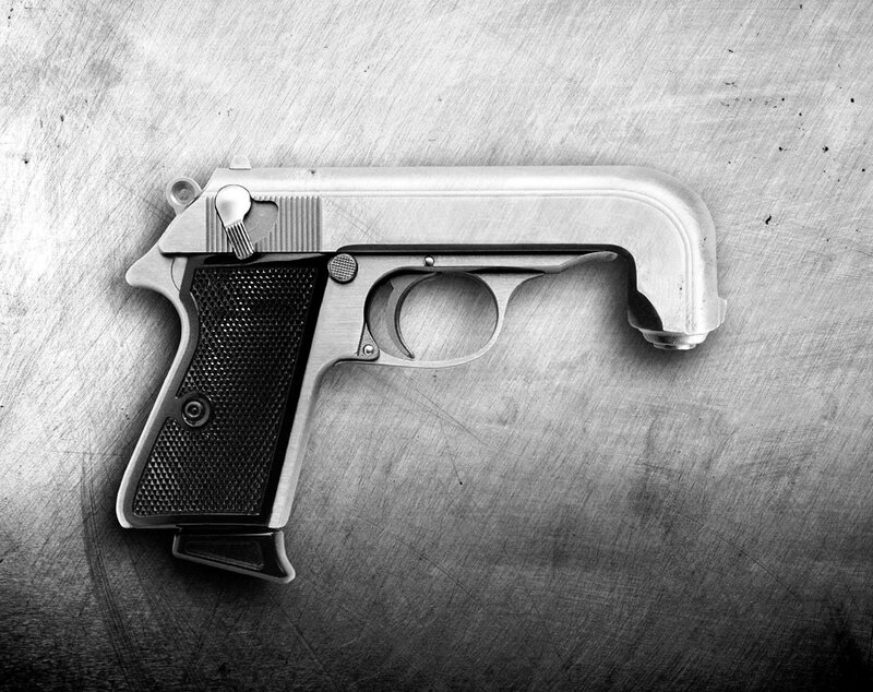 Pistol on Metal Surface