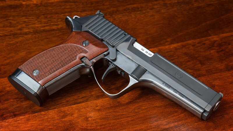 Pistol on Wooden Surface — Brown
