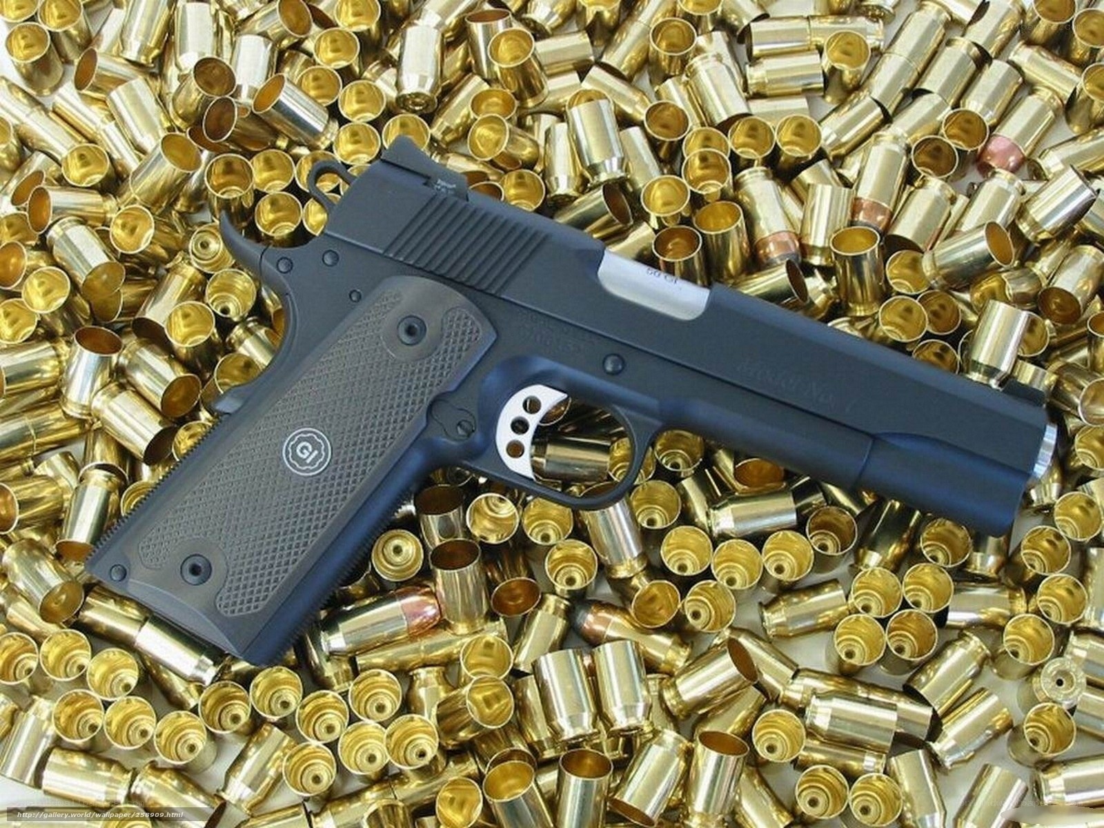 pistol surrounded by bullet casings