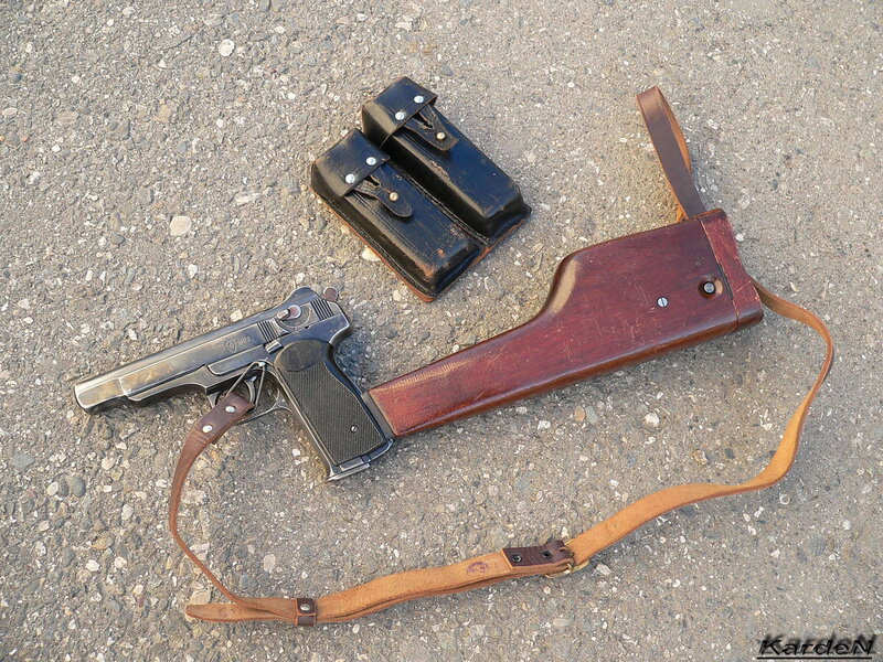 Pistol with accessories on pavement