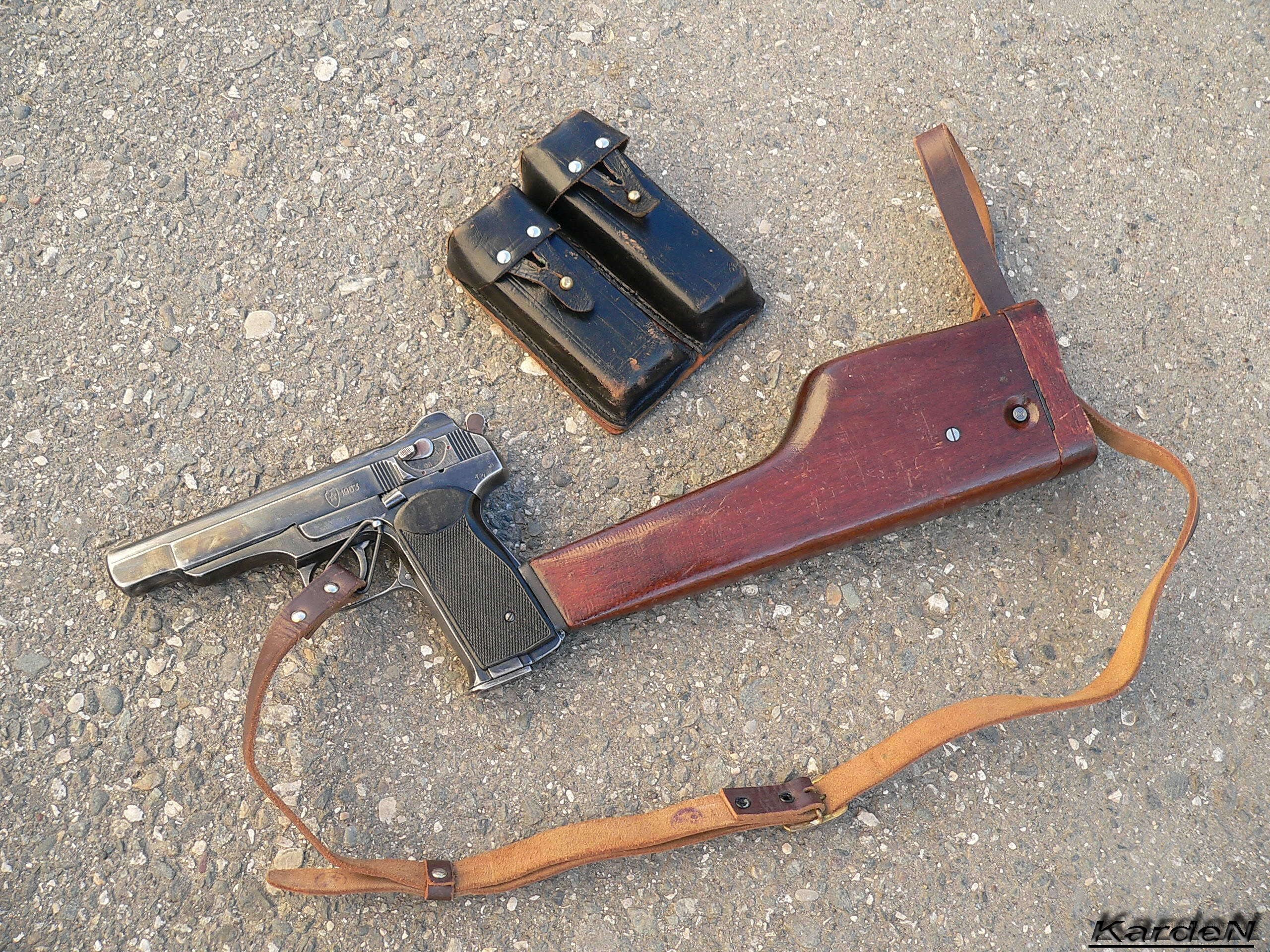 Pistol with accessories on pavement