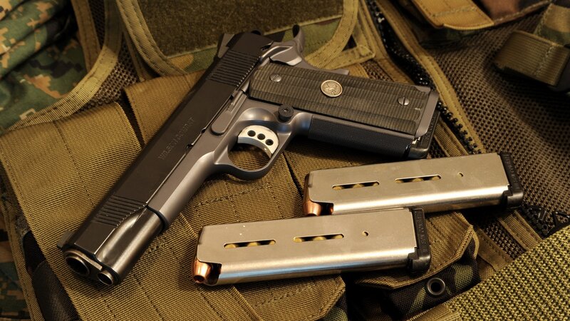 pistol with magazines on vest