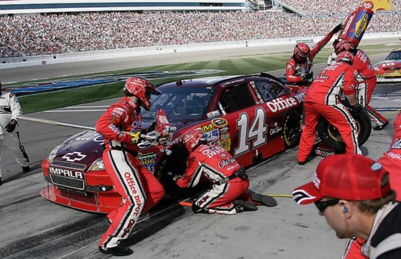 Pit Crew Changing Tire — Red