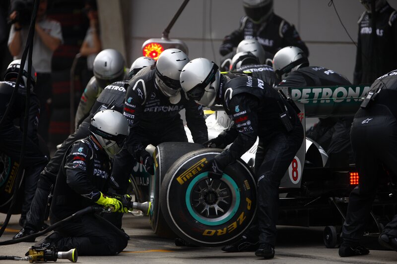 Pit Crew Changing Tire