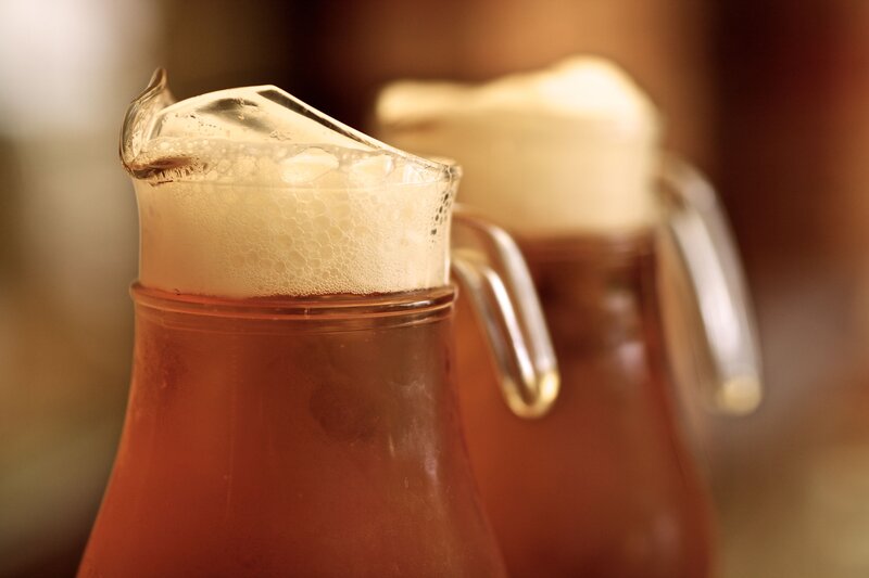 Pitchers of beer with foam