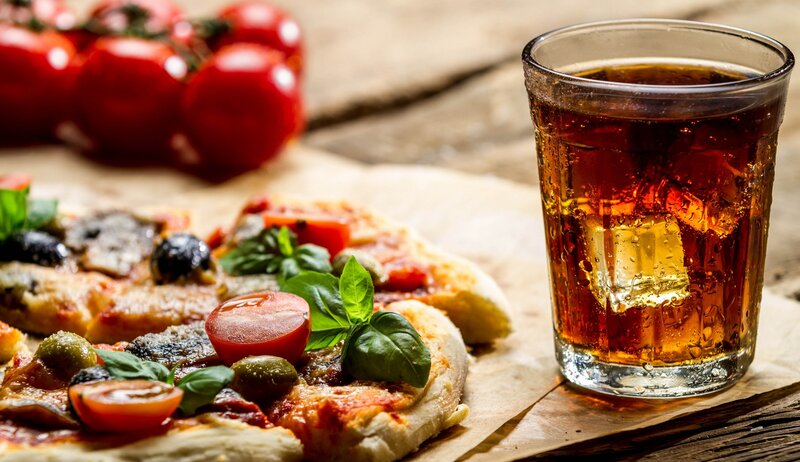 pizza and soda on wood