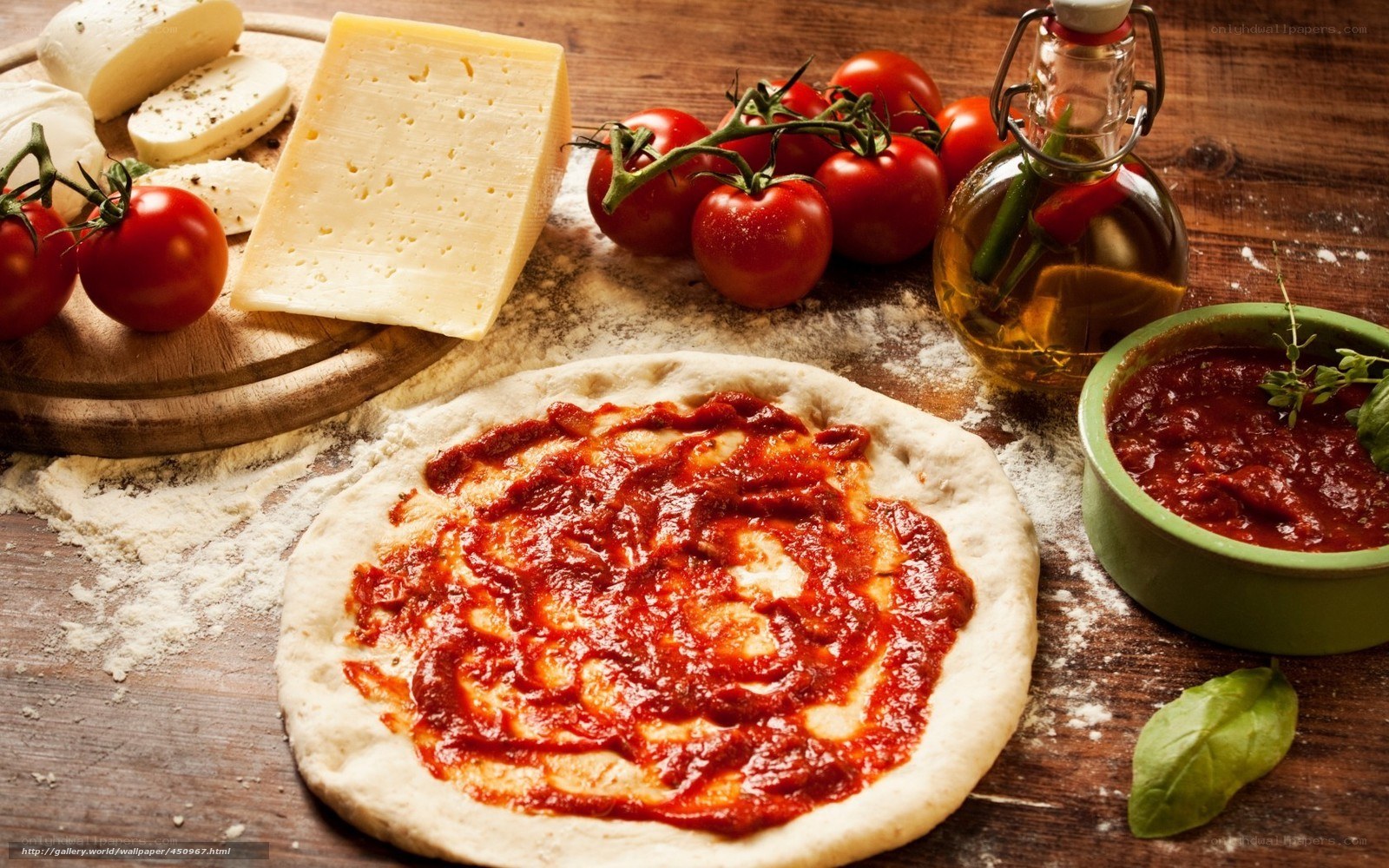 Pizza ingredients on wooden table