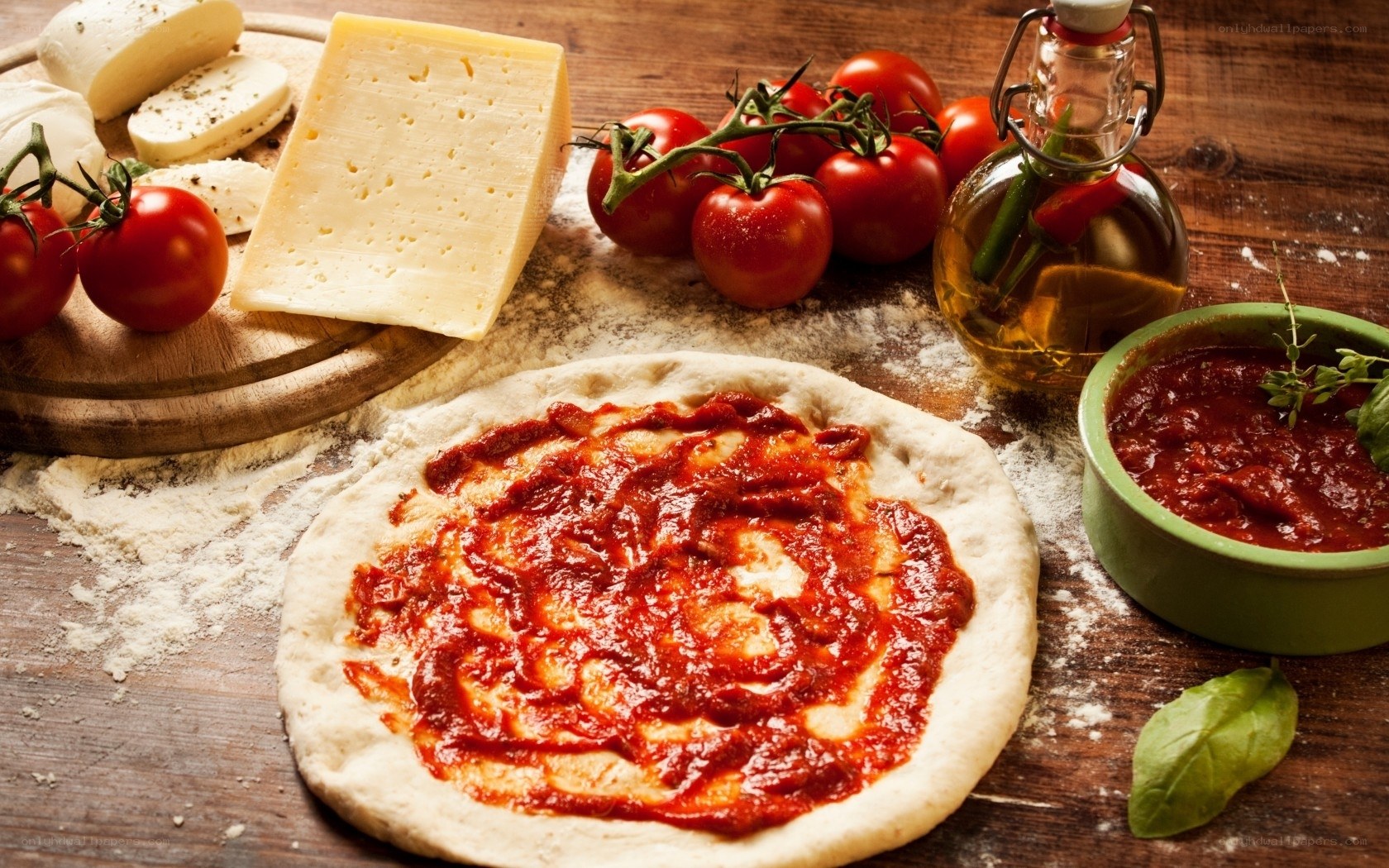 Pizza ingredients on wooden table