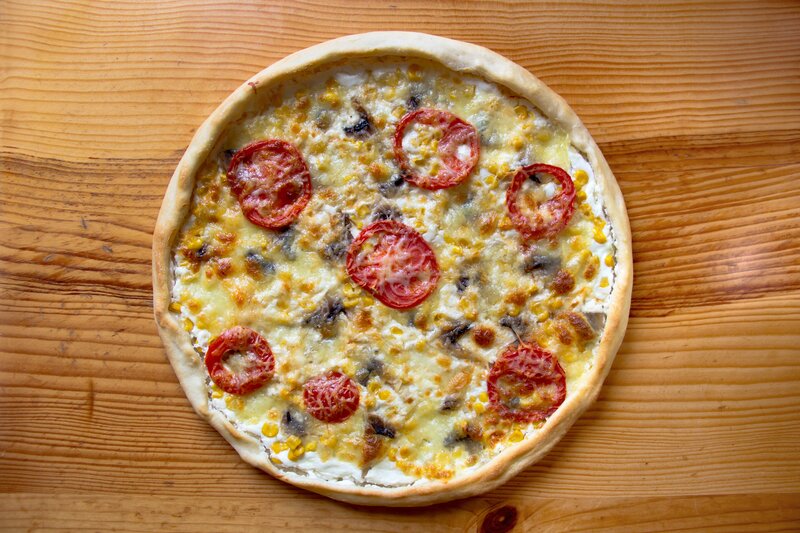 pizza with tomatoes and corn