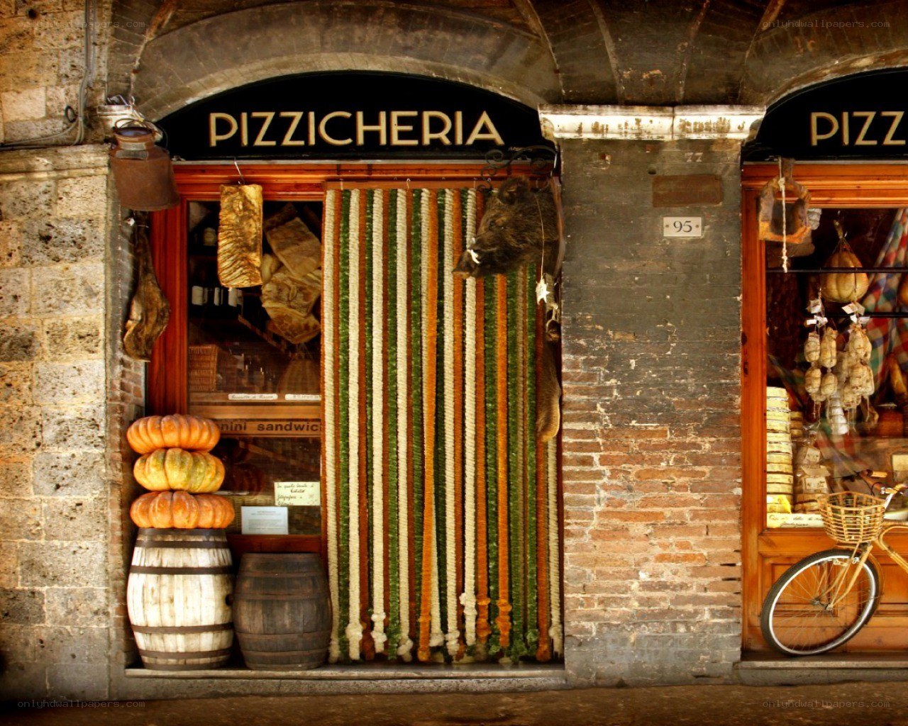 Pizzeria storefront with cured meats