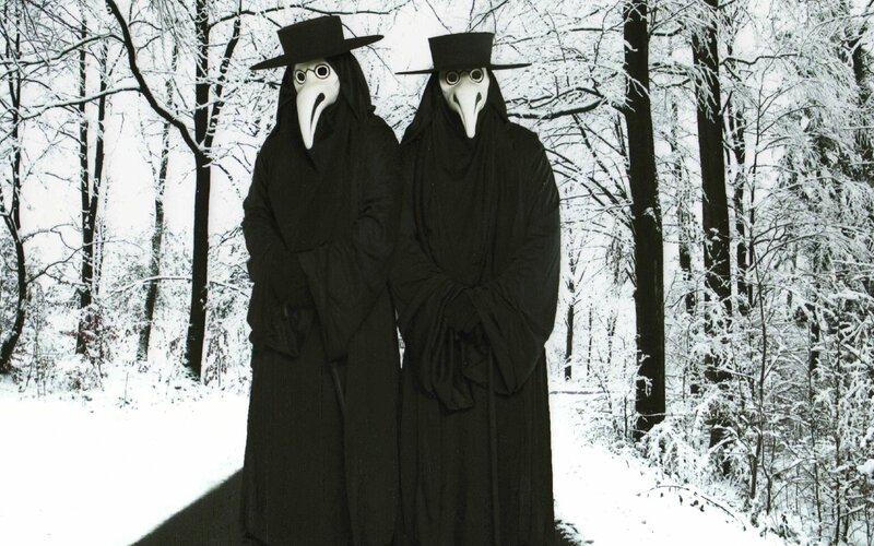 Plague doctor figures in snow