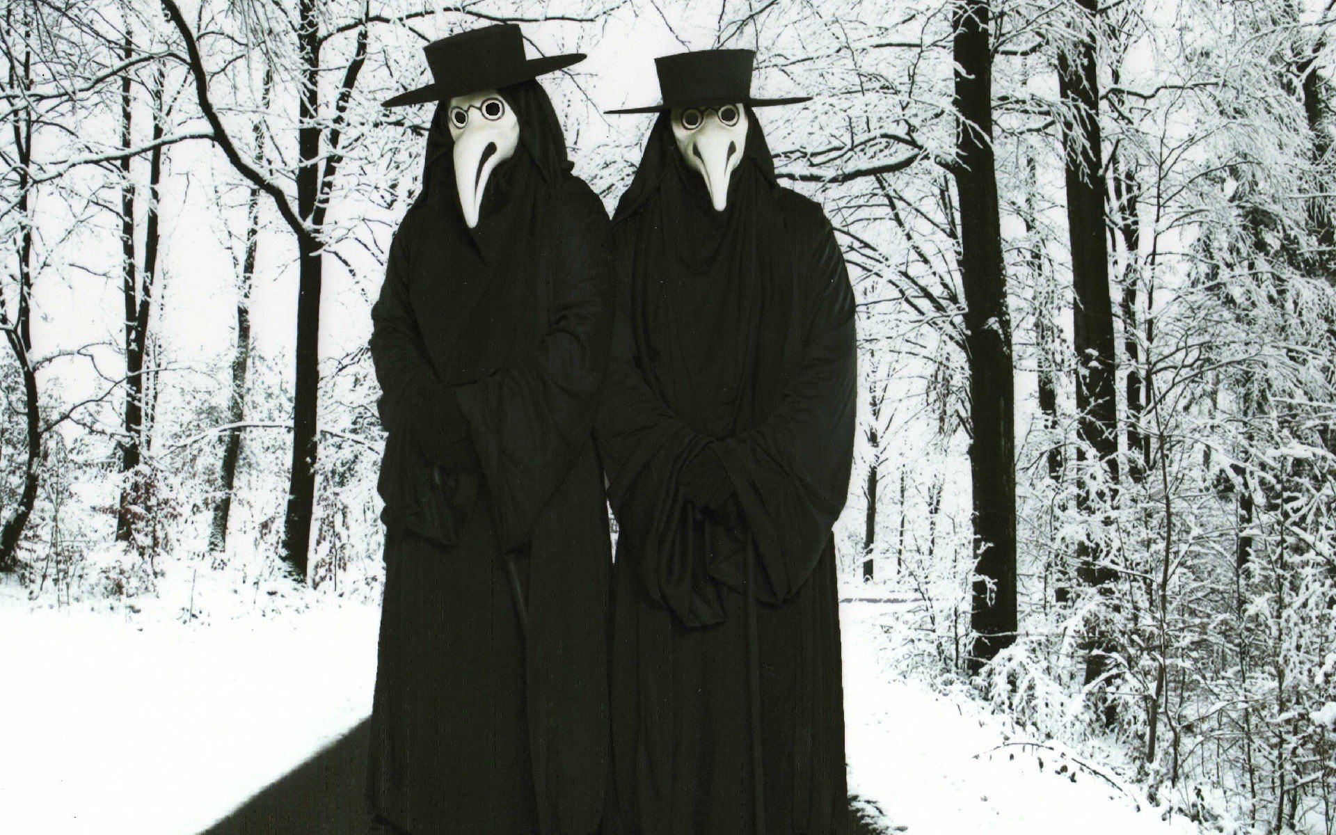 Plague doctor figures in snow