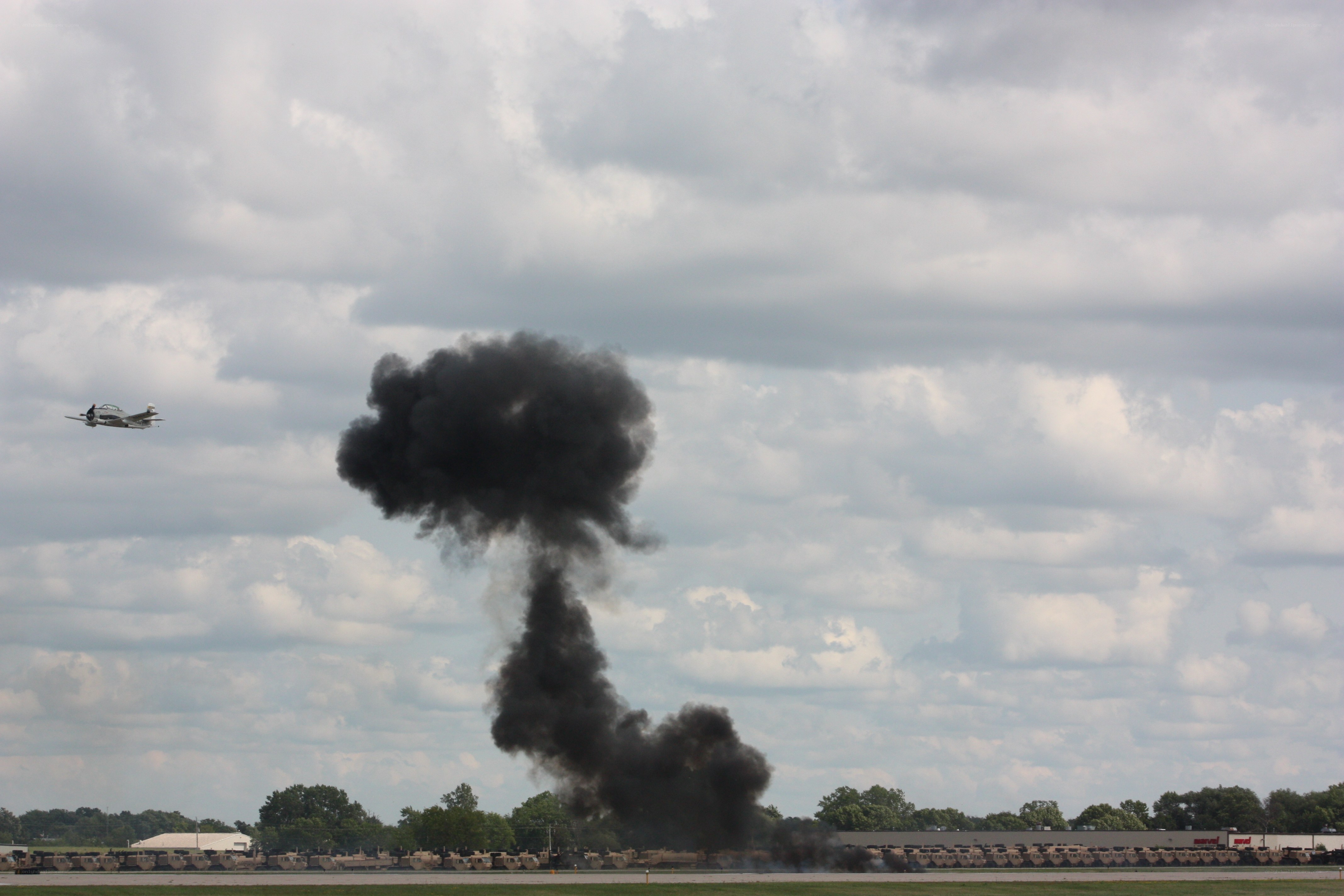 Plane flying near black smoke