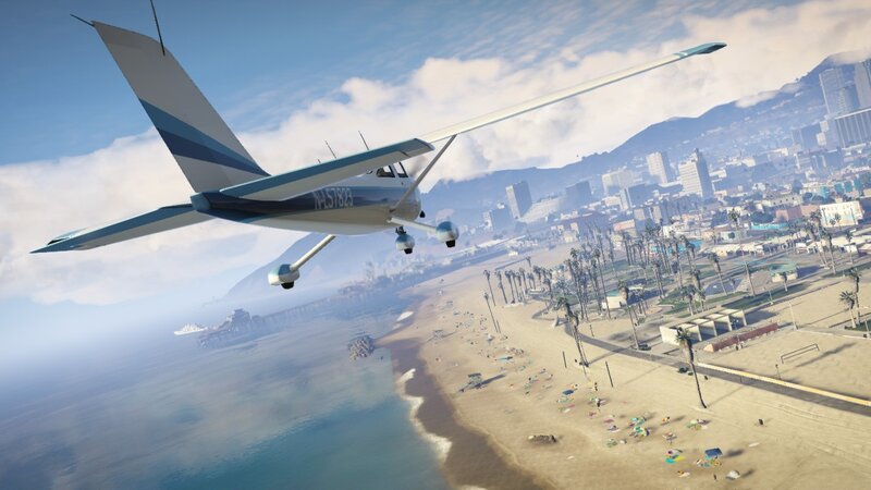 Plane flying over beach city