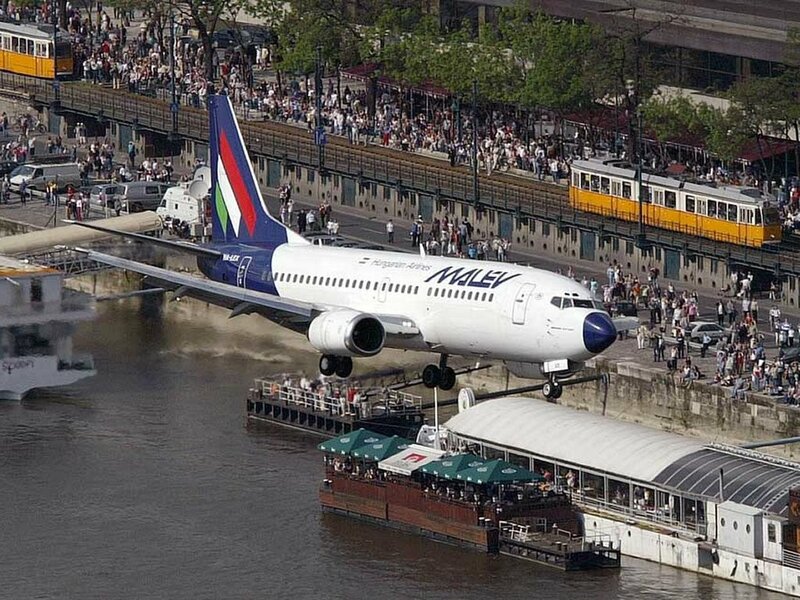 Plane taking off over river