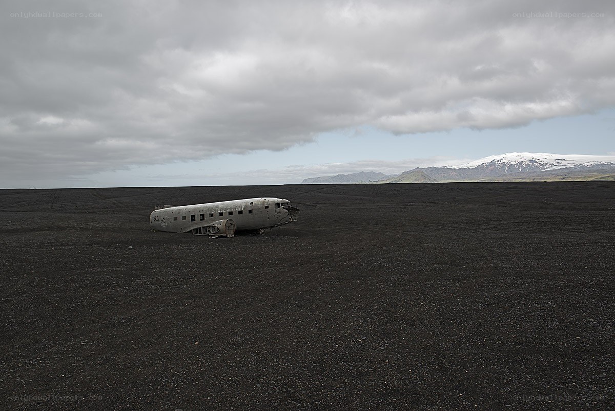 Plane wreck on black sand