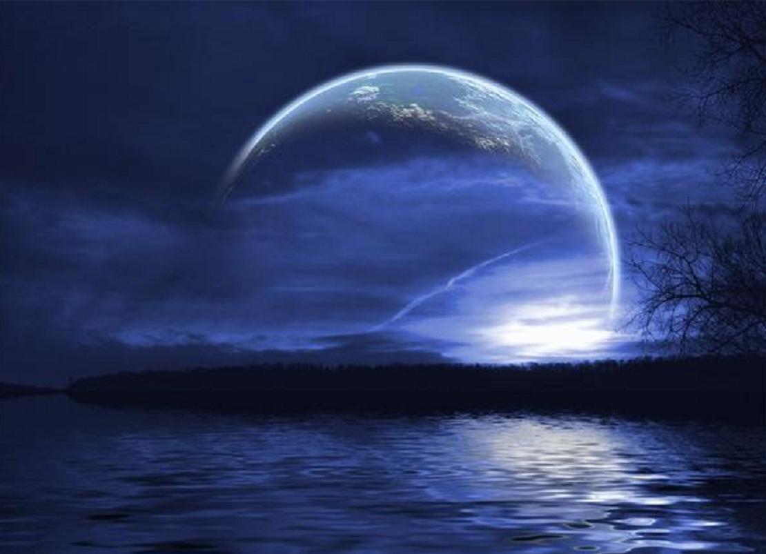 Planet rising over water