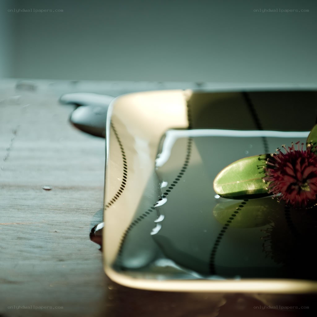 plate with flower on wooden table