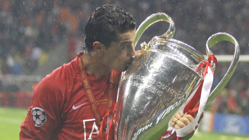 Player kissing trophy in rain
