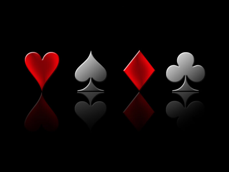 Playing card suits on black background